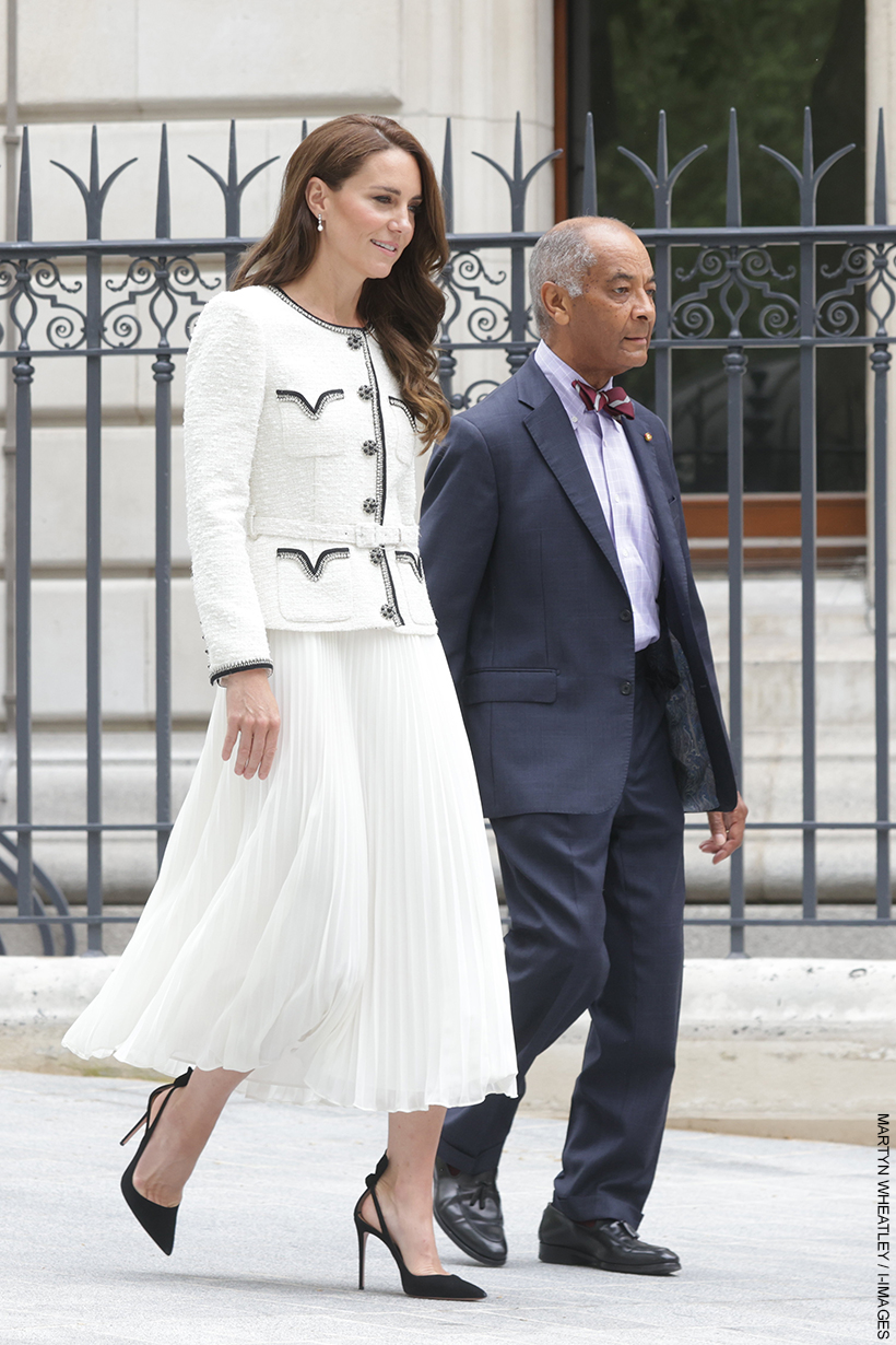 Kate Middleton wearing a white Self Portrait dress, carrying a Chanel clutch and wearing black slingbacks from Aquazzura at the National Portrait Gallery today