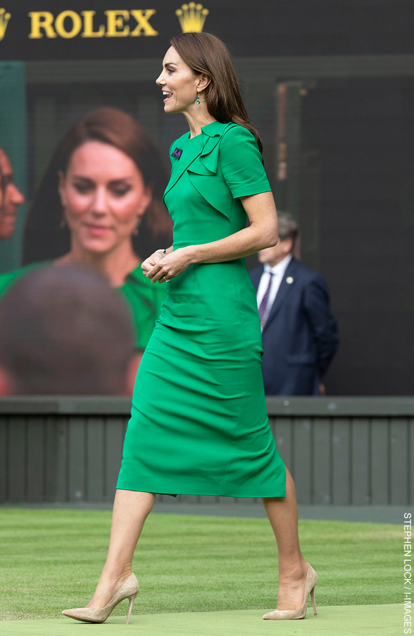 Kate Middleton walking on centre court in her green dress and beige shoes.