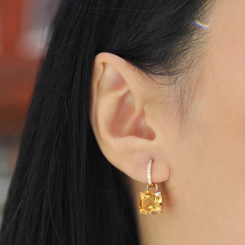 Model wearing the citrine gemstone earrings on diamond hoops
