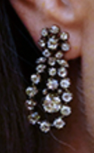 A look at the diamond chandelier earrings, which feature a cluster stud with a floral motif, and a pendant of diamonds surrounded by a diamond frame.