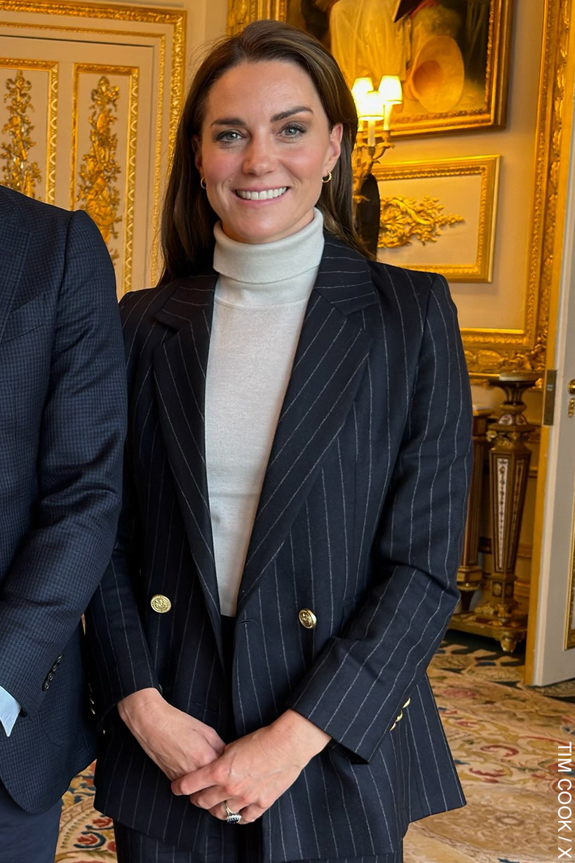 Princess of Wales wearing the pinstripe suit and cream roll neck.