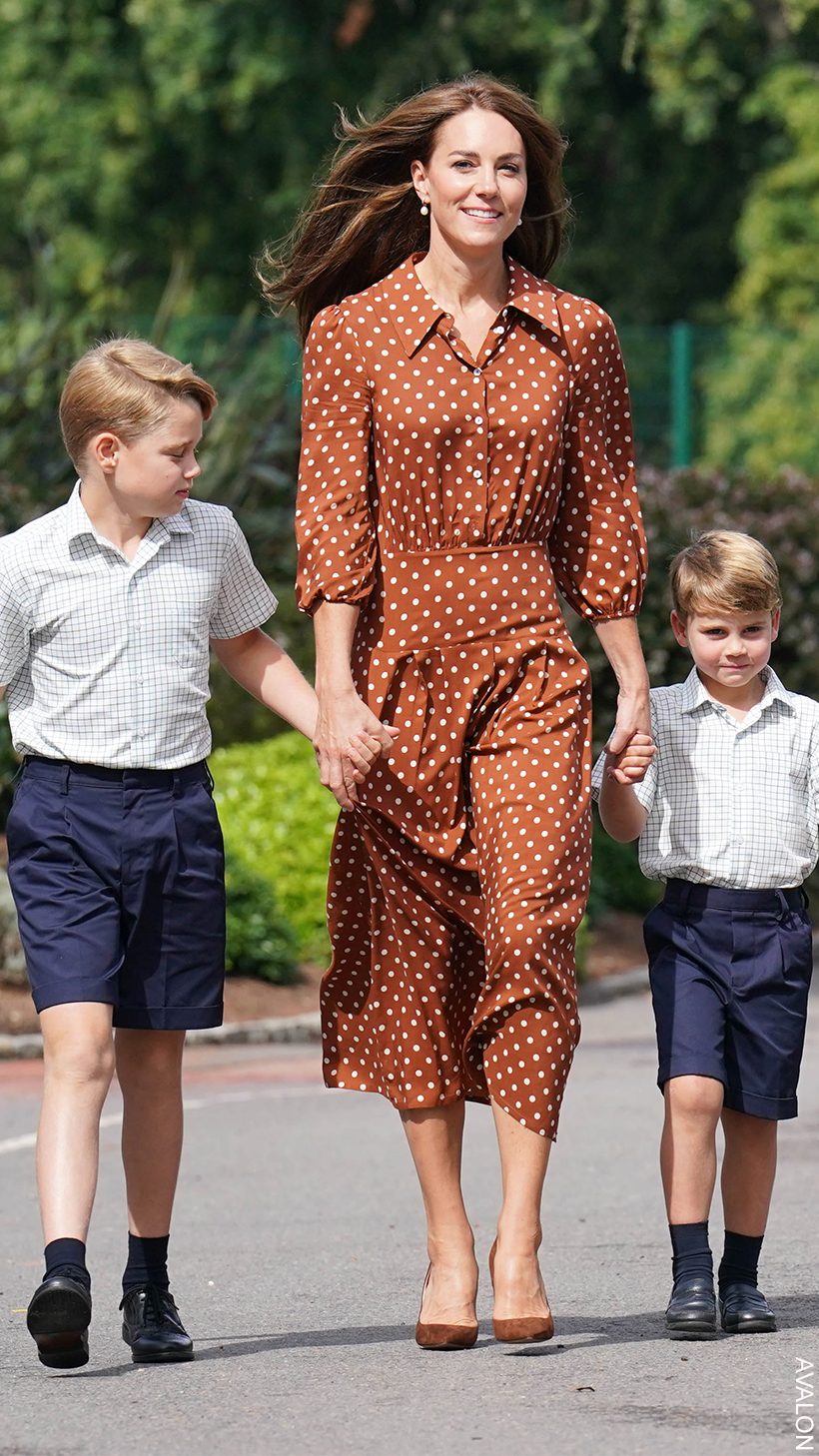 Kate Middleton on the school run wearing a rust brown dress with polka dots, that hits just below the knee.  
