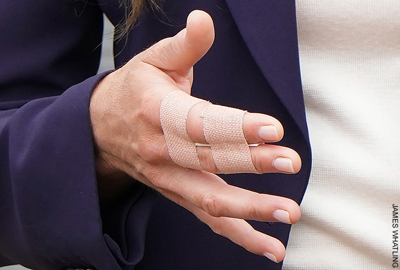 Kate Middleton's fingers taped up following a trampoline accident.  Index and middle finger are taped together with flesh coloured plasters.