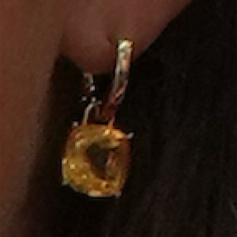 Close up of Kate's gold and citrine earrings.