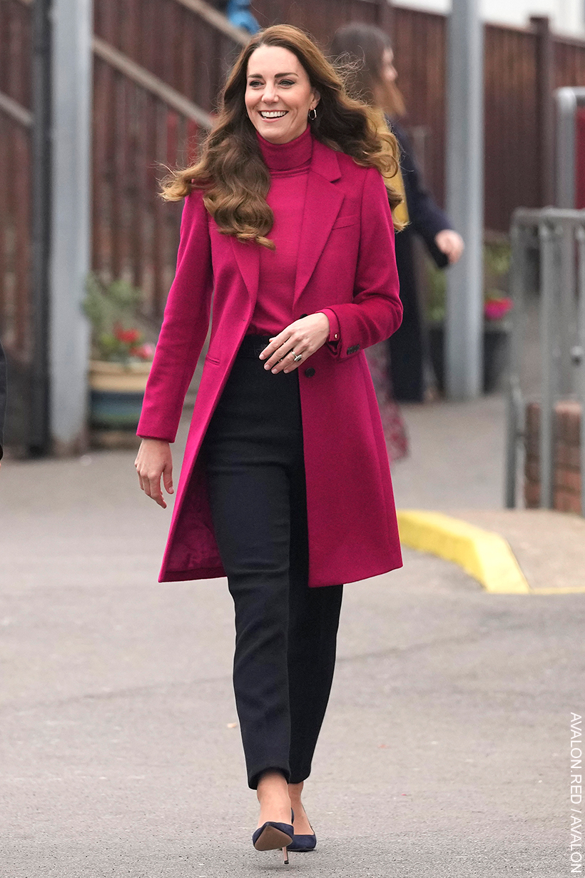 Kate Middleton dressed for autumn in a tonal berry pink coat and roll neck sweater with trousers.