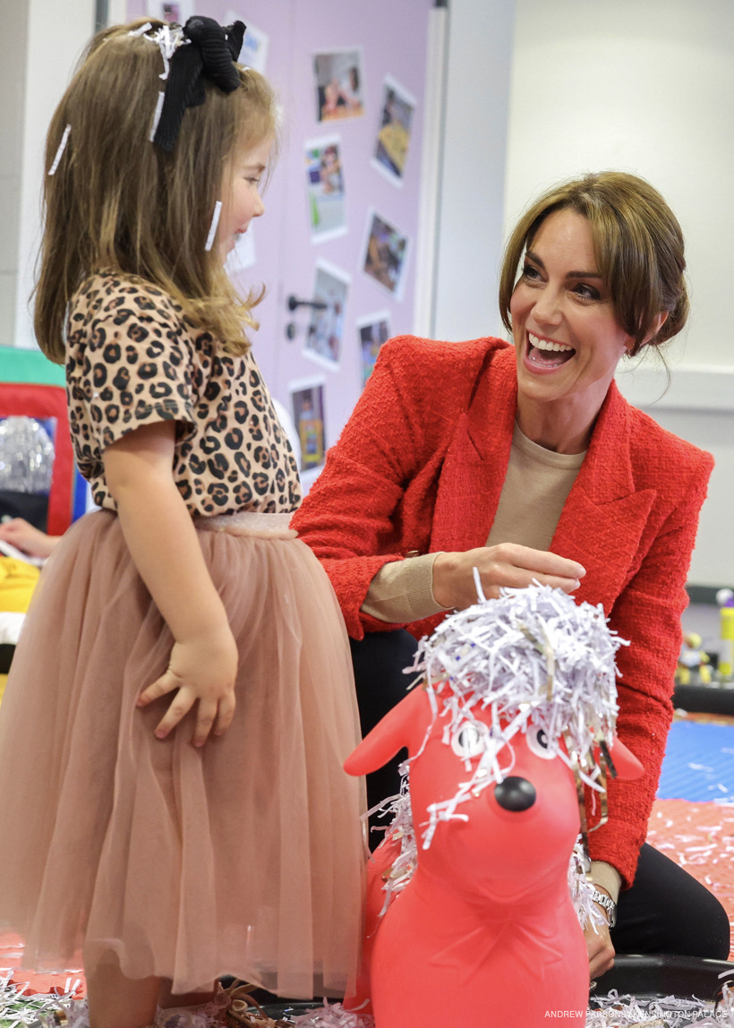 Kate Middleton laughing with a child at a family portage session in Kent.