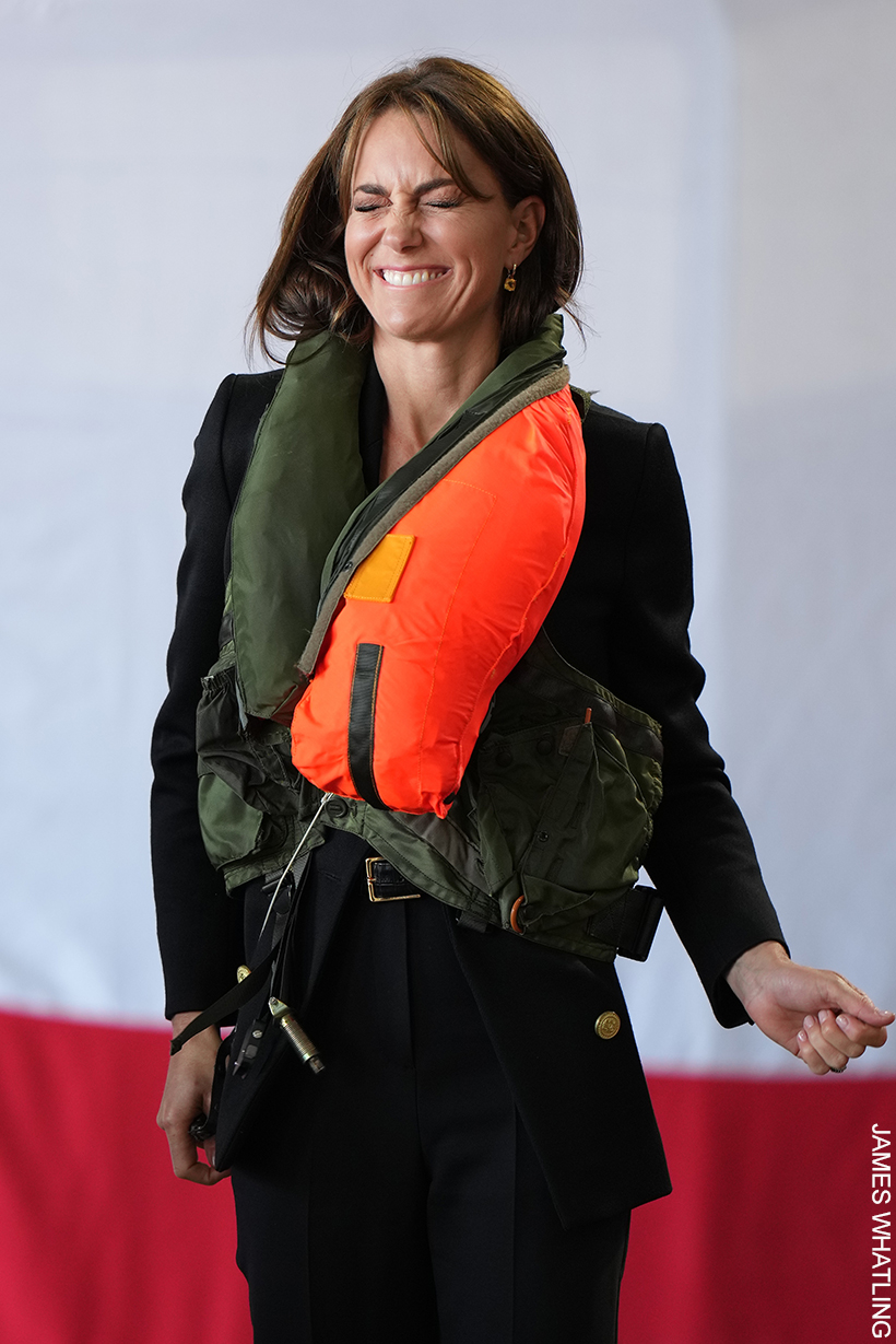 Kate pulls an uncomfortable-but-smiley face as her life jacket inflates.