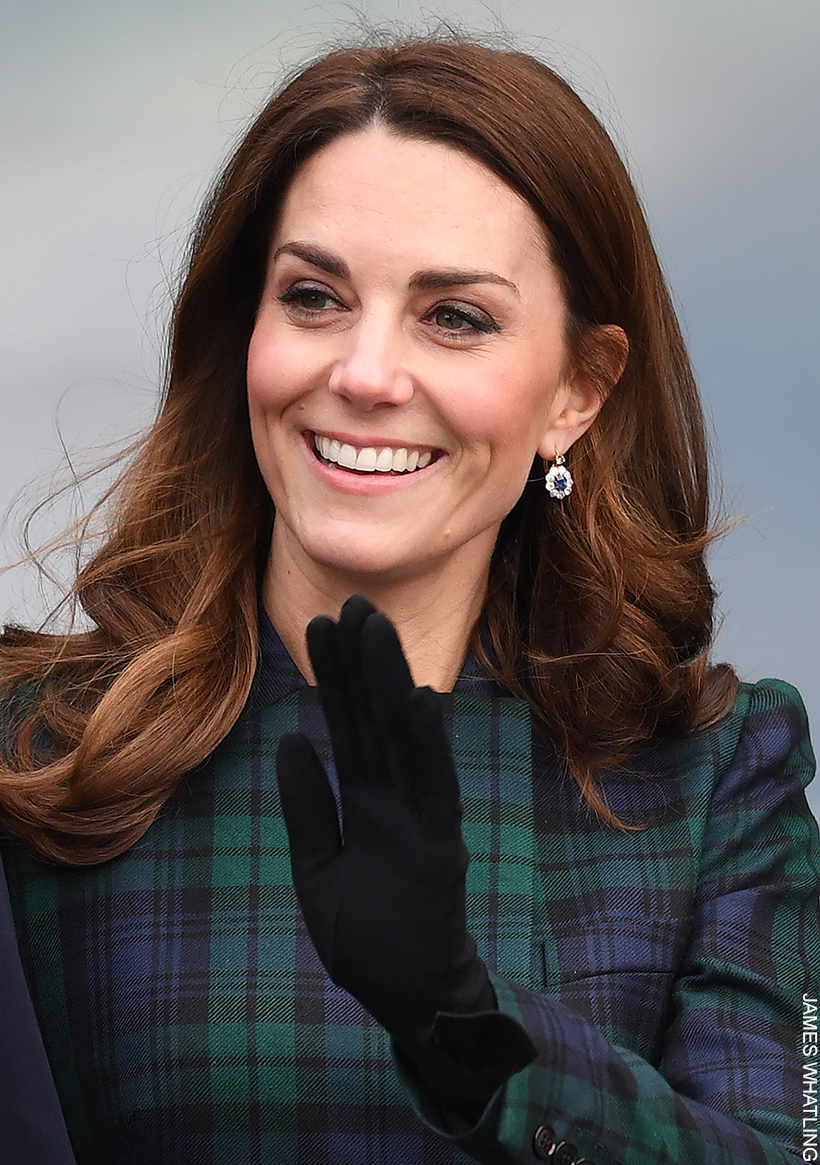 Kate Middleton wearing a pair of black wool gloves with a bow on the cuff.