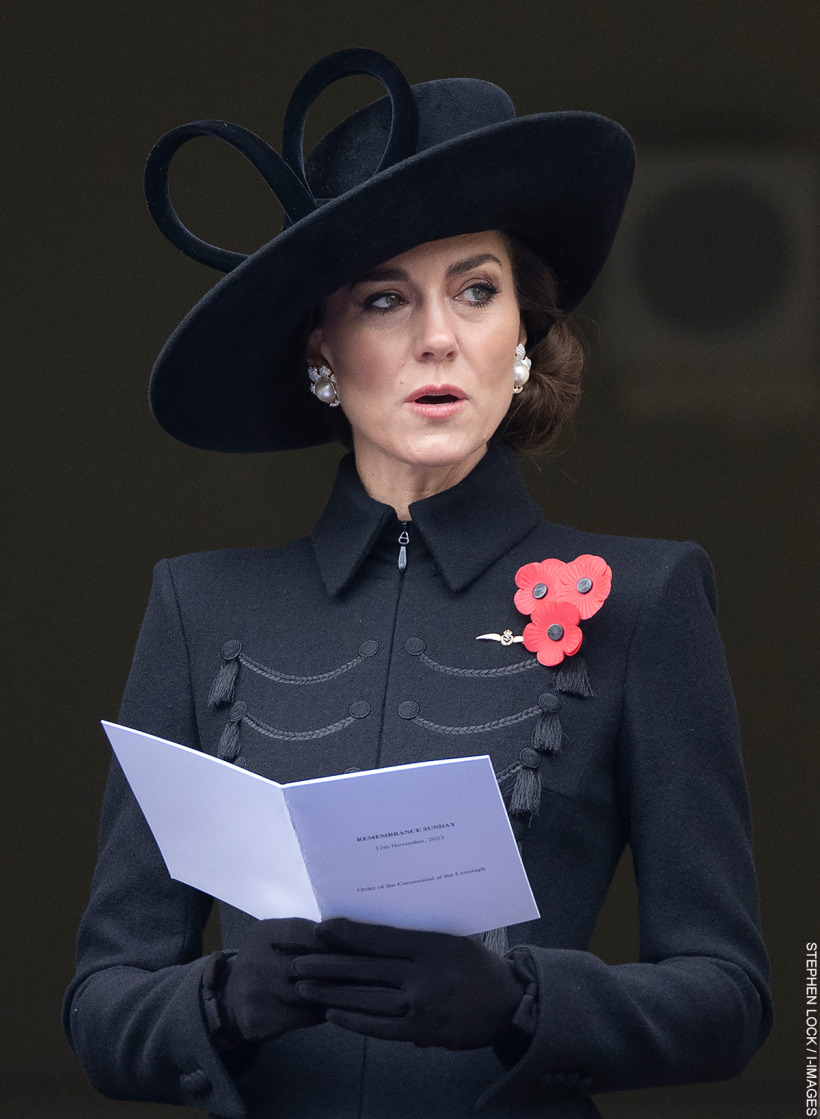 The Princess of Wales wearing a dark coat and matching wide-brimmed hat, her refined look accentuated by  classic pearl and diamond earrings and a cluster of poignant red poppies.