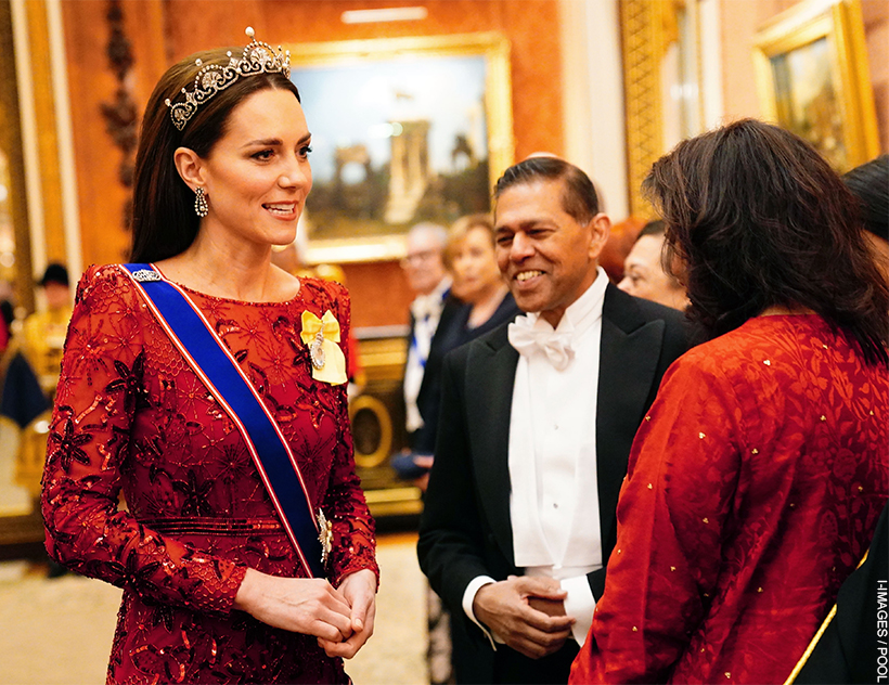 The Princess of Wales wears the Lotus Flower Tiara on top of her brown slicked back hair.  She pairs the gem with another red dress, this time featuring intricate beading. 
