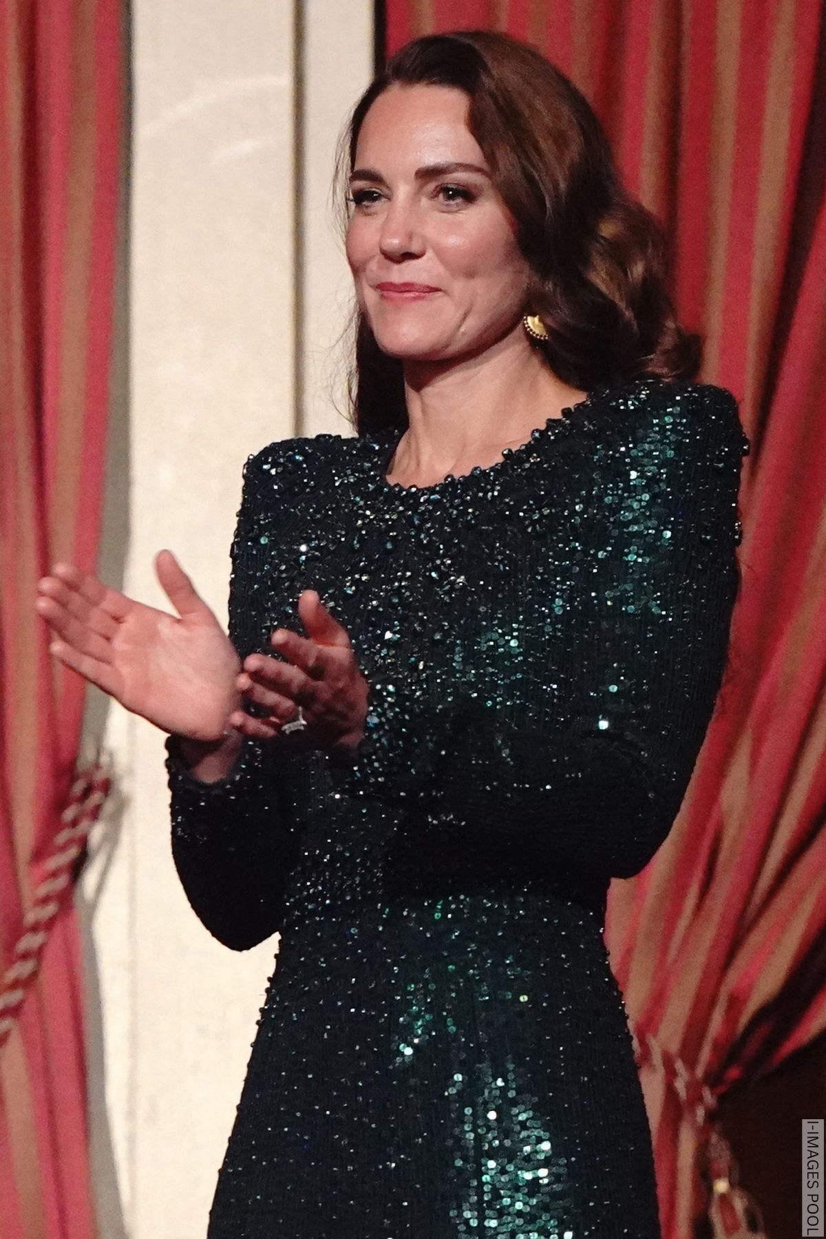 Kate Middleton wearing a green sequin dress, clapping at The Royal Variety Performance