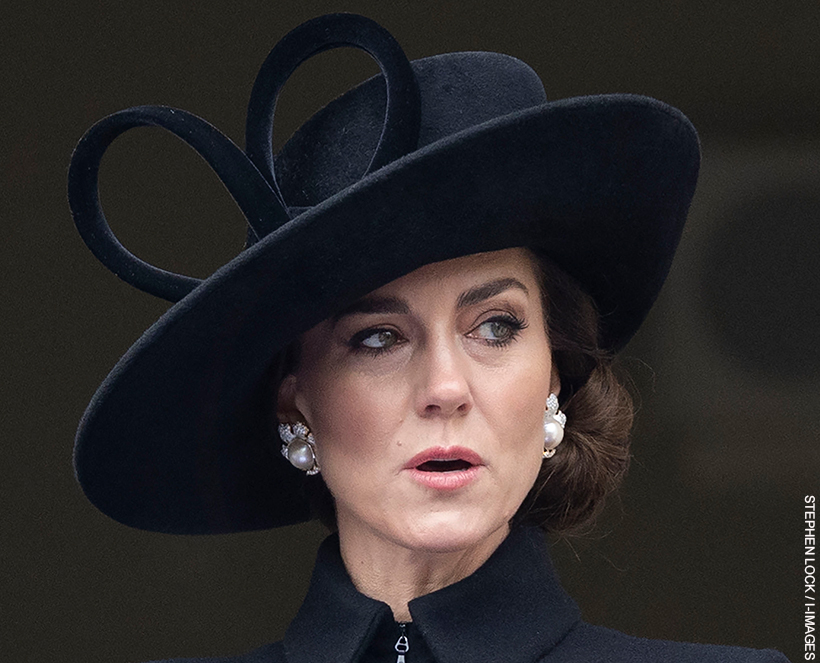Kate Middleton wearing a black large brim hat and distinctive pearl and diamond earrings