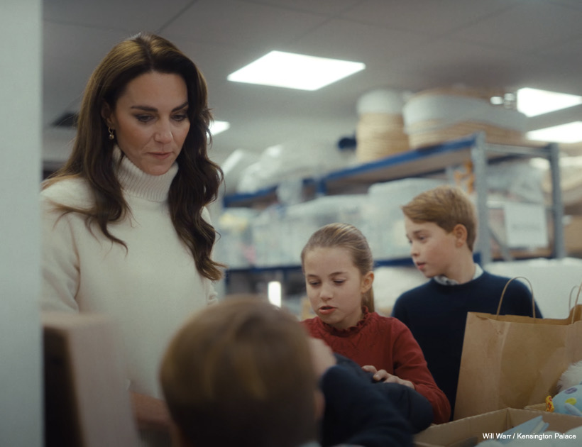 Kate, George, Charlotte and Louis peer into boxes and bags of donations.