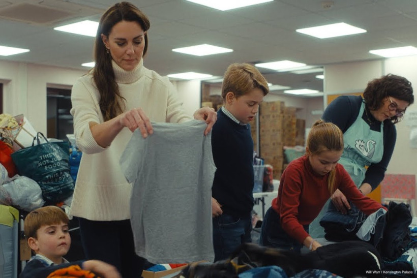 Kate, George, Charlotte and Louis sort through piles of donations.