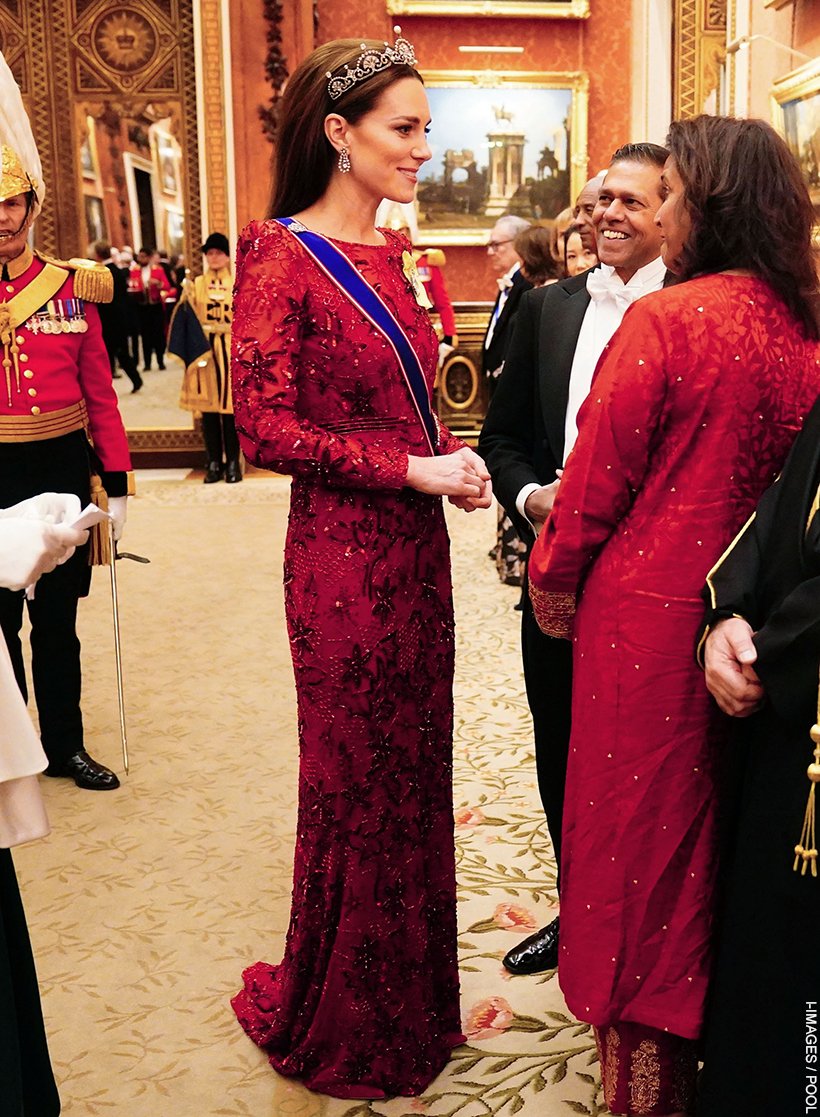 Princess Kate greeting guests in a sequinned red gown by Jenny Packham at the Diplomatic Reception, complemented by the Lotus Flower Tiara.