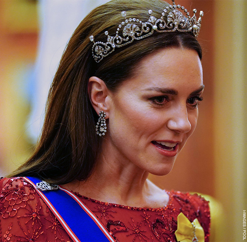 Kate Middleton wears the lotus flower tiara and a pair of diamond earrings with a red gown at a Diplomatic Reception. 
