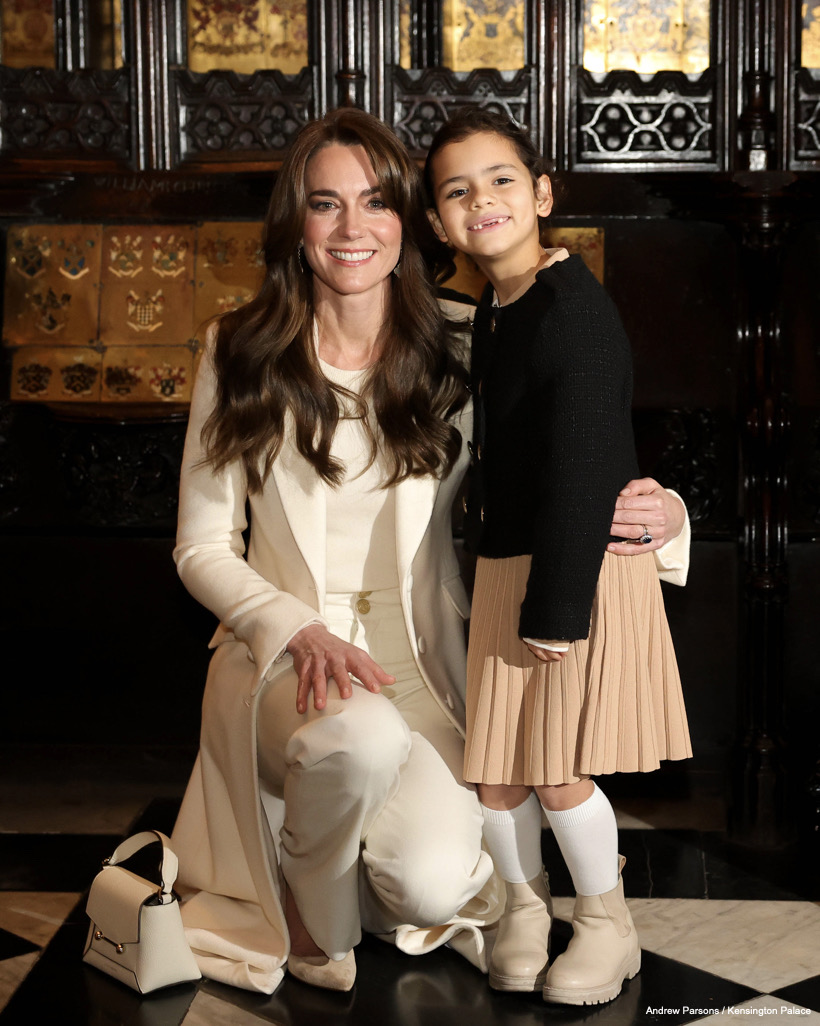 Kate Middleton and a little girl pose for a photo at the Together at Christmas concert.