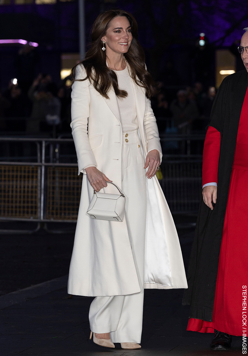 The Princess of Wales walks into the 2023 'Together At Christmas' Carol Concert wearing an ivory ensemble.