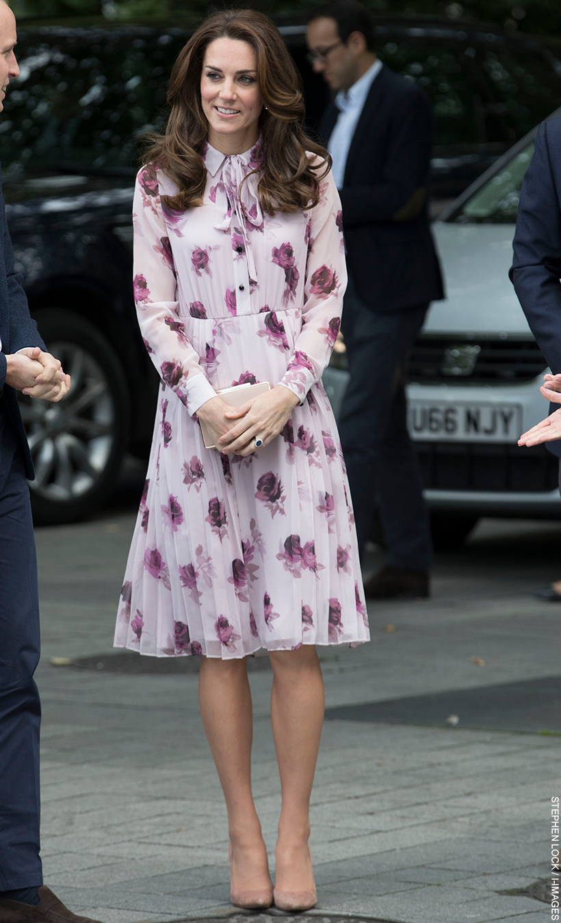 Kate Middleton sports a big bouncy blow dry and a pinky-purple rose print frock.