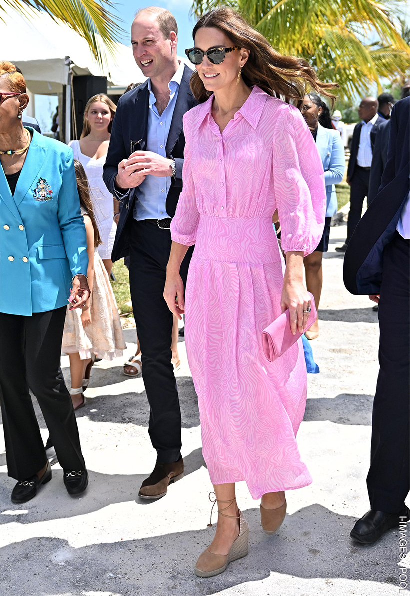 Kate Middleton looks sunshine ready in a bubblegum pink midi dress, wedges and sunglasses. 