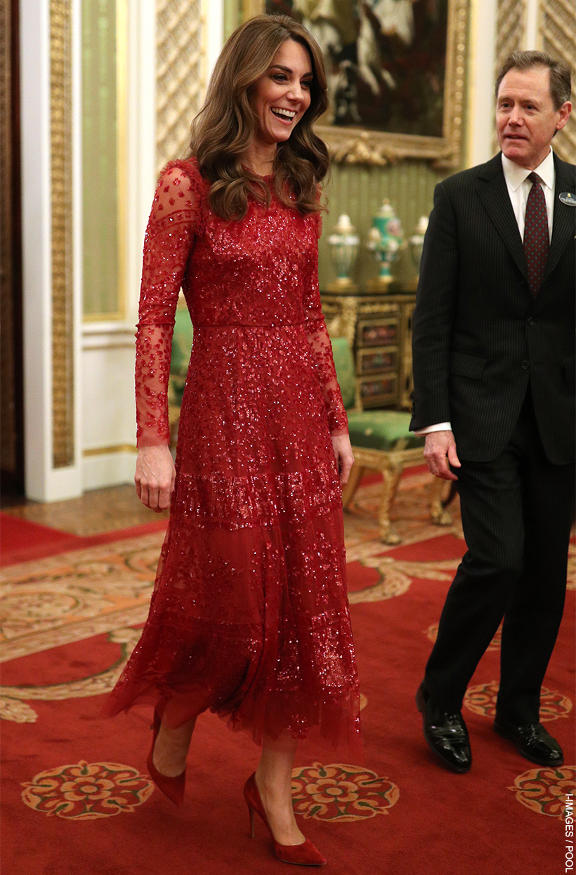 Kate Middleton wearing a glittering red midi dress with tulle and sequins.