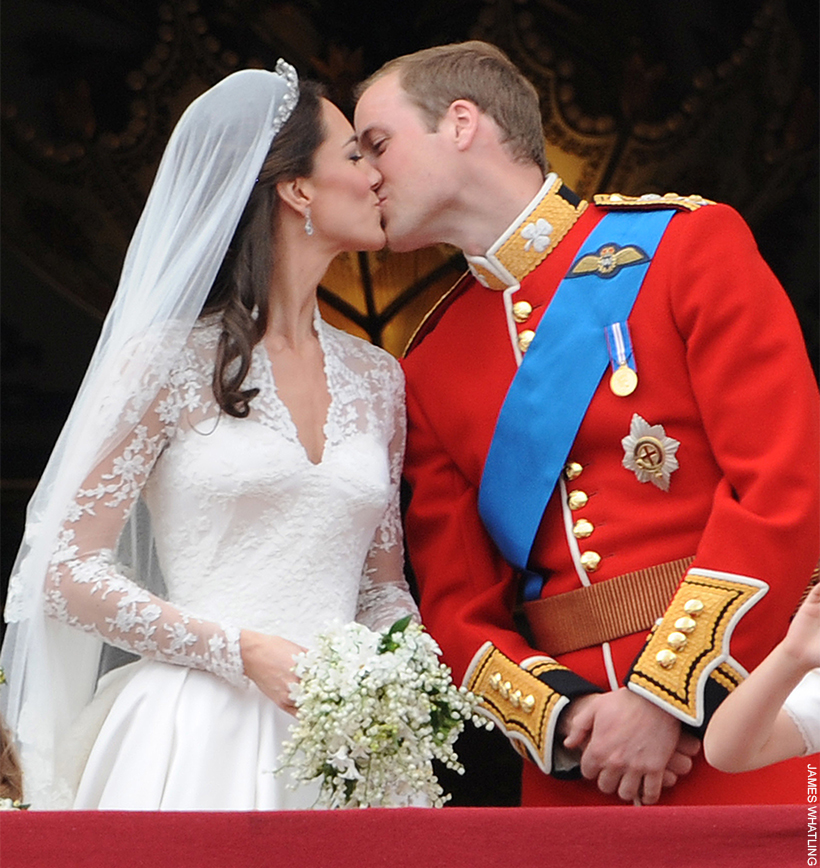 William and Kate share a kiss on the balcony of Buckingham Palace, dressed in their wedding gear. 