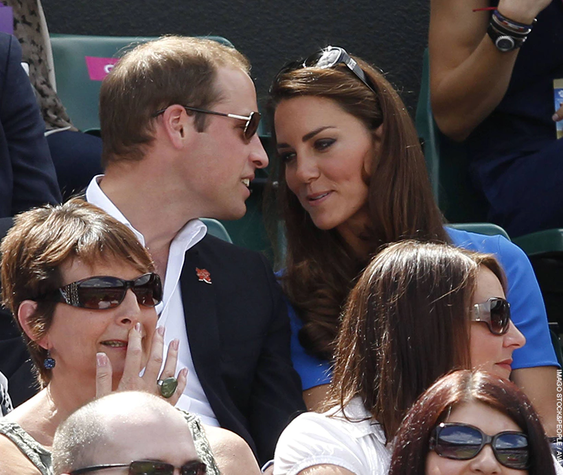 Prince William and Kate Middleton share a whisper at Wimbledon.  The 