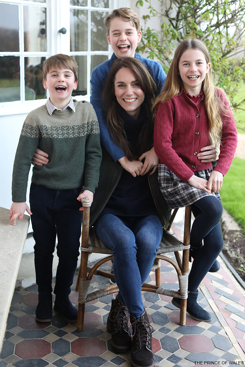 Kate Middleton sits in the middle of her three children, smiling, in this mother's day photo.