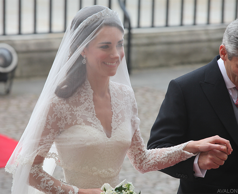 Kate Middleton, wearing the Cartier Halo Tiara and veil, walking into Westminster Abbey on her wedding day.