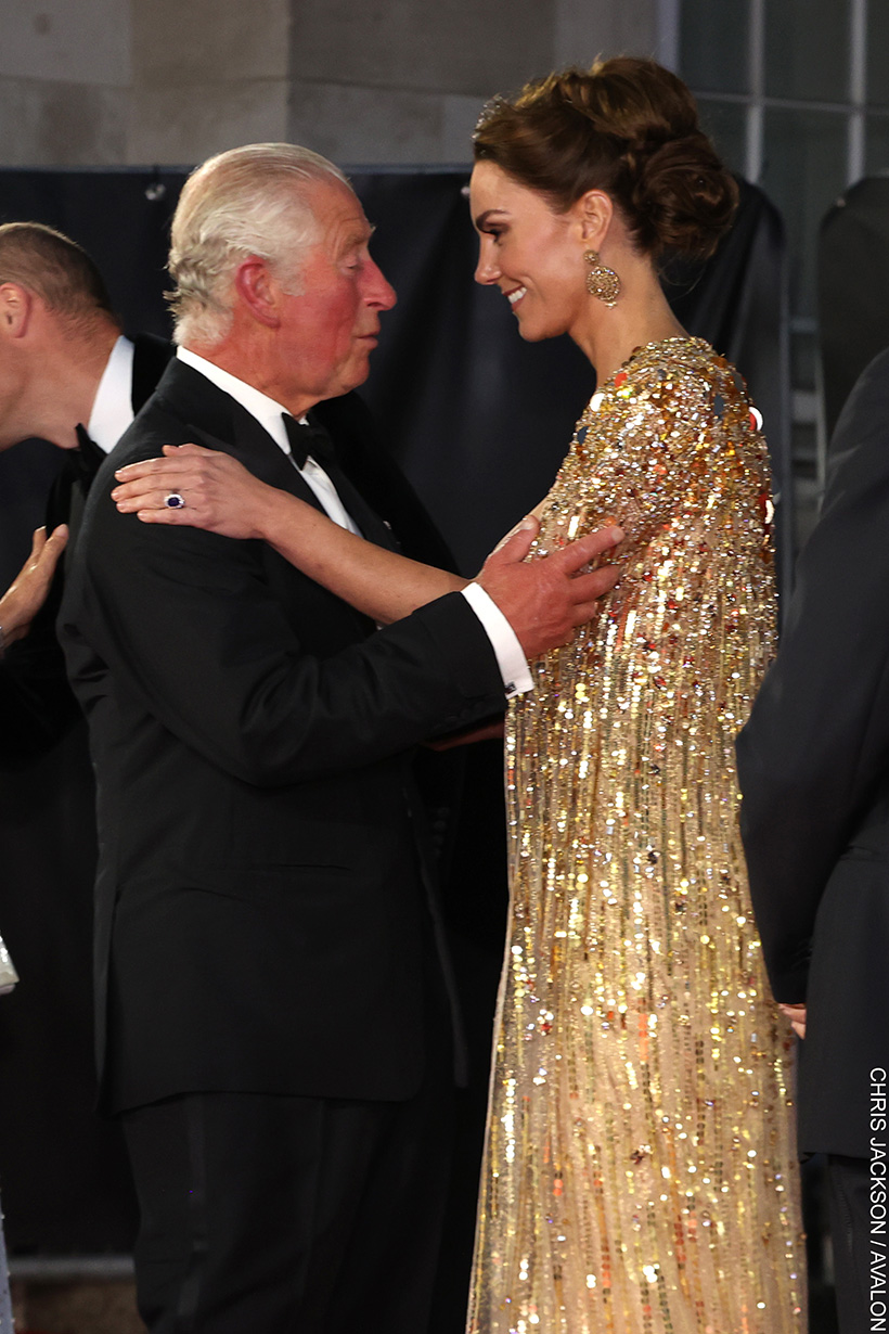 King Charles and The Princess of Wales embrace.  Both are wearing formal ensembles. 