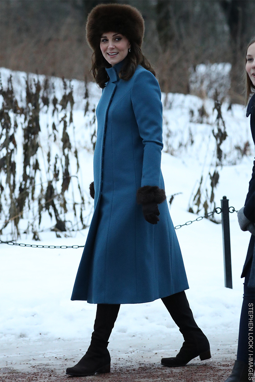 Kate Middleton, 6-7 months pregnant during her mini tour of Scandinavia in 2018, wearing a vibrant blue maternity coat by Catherine Walker & Co, designed to accommodate her growing bump. She wore this stylish coat during her visit to Oslo, Norway.

