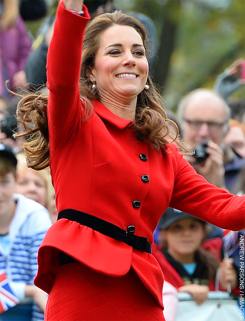 9 times Kate Middleton altered & upcycled her outfits 5 Kate Middleton wearing a vibrant red Luisa Spagnoli suit with a black belt and pearl earrings during her visit to Christchurch. she is attempting to catch a cricket ball.