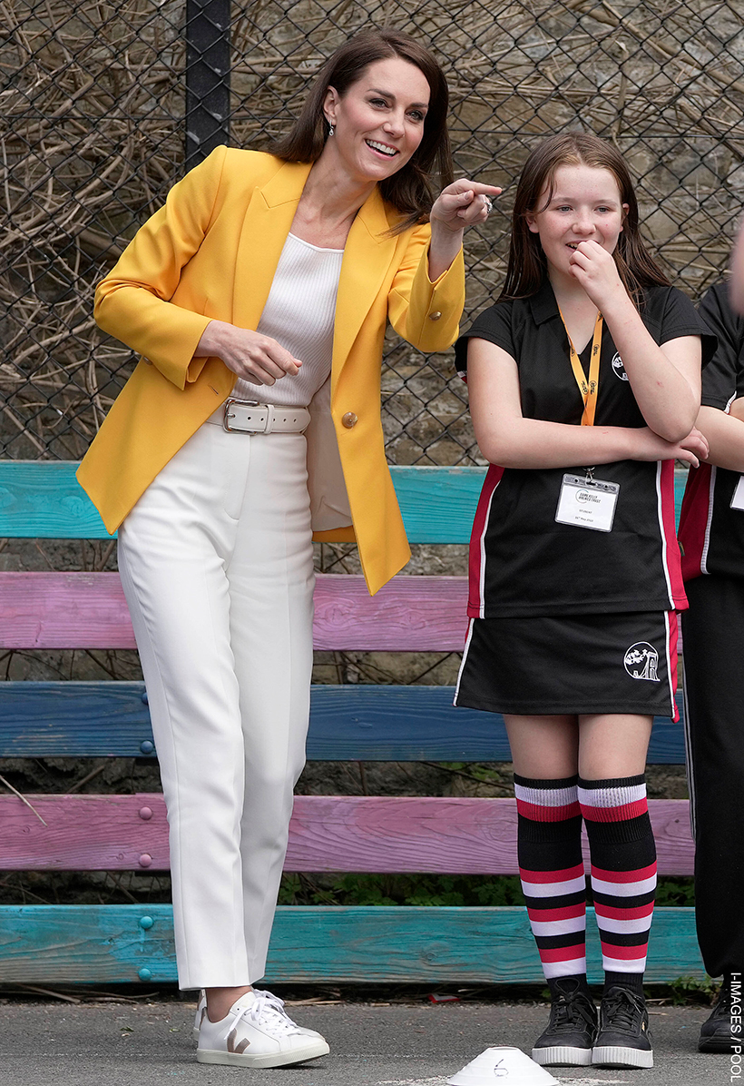 Kate Middleton wears white cigarette pants, sneakers and bright blazer