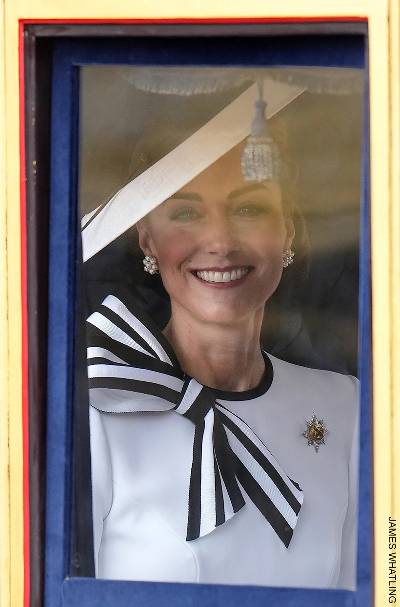 Kate Middleton smiles as she peers through the window of the Glass Coach at Trooping the Colour