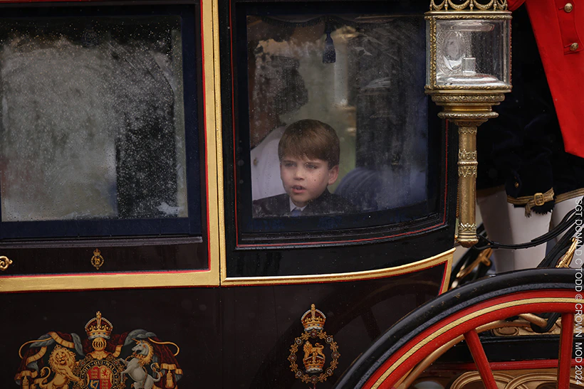Louis looks out of the window of the Glass Coach as it mists up