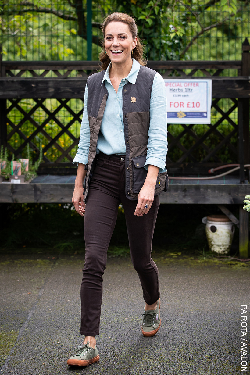 Kate Middleton looks super casual in this outfit, comprising brown jeans, green sneakers, a blue shirt and a padded gilet.