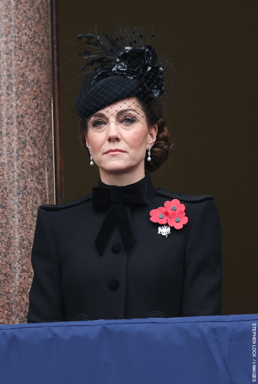 The Princess of Wales stood on the Foreign Office balcony on Remembrance Sunday looking sombre, wearing a black coat, black hat with floral detailing and diamond and pearl earrings