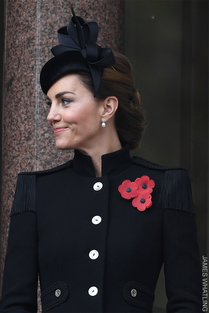 Kate Middleton pins three poppies to her coat on Memorial Day