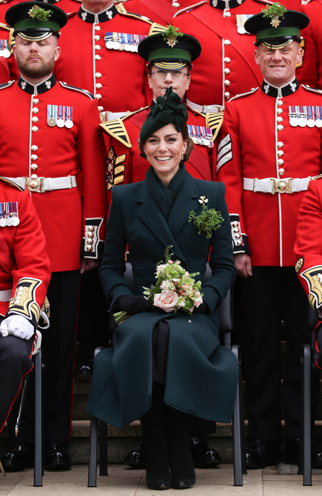 The Princess of Wales Attends the Irish Guard’s St Patrick’s Day Parade wearing a green coat, seated, in front of Irish Guards in red regimental dress