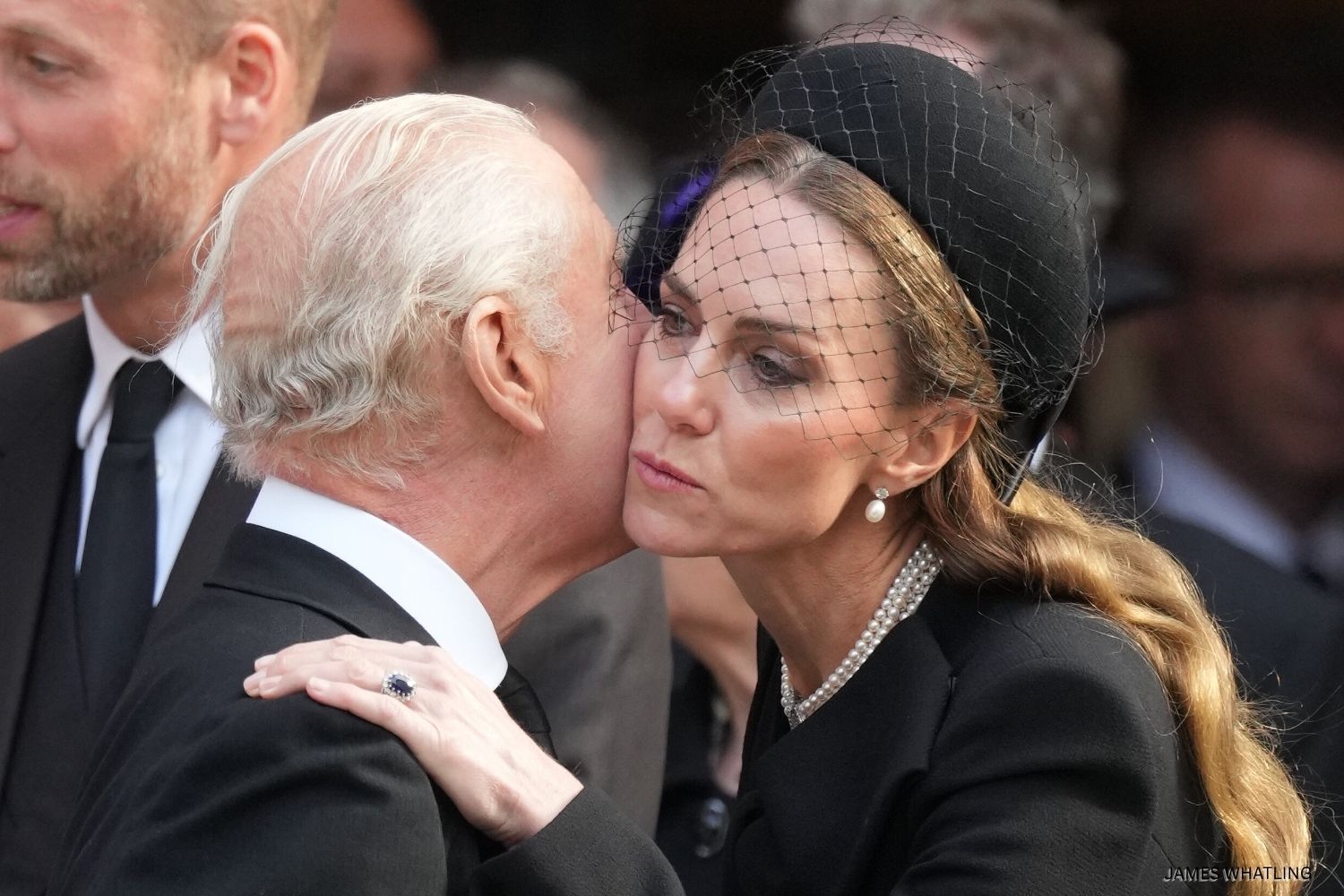 The Princess of Wales receiving a kiss on the cheek from King Charles following the funeral today