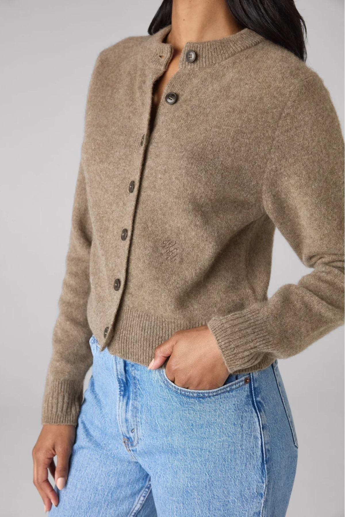 A tight cropped shot of the cardigan on the model