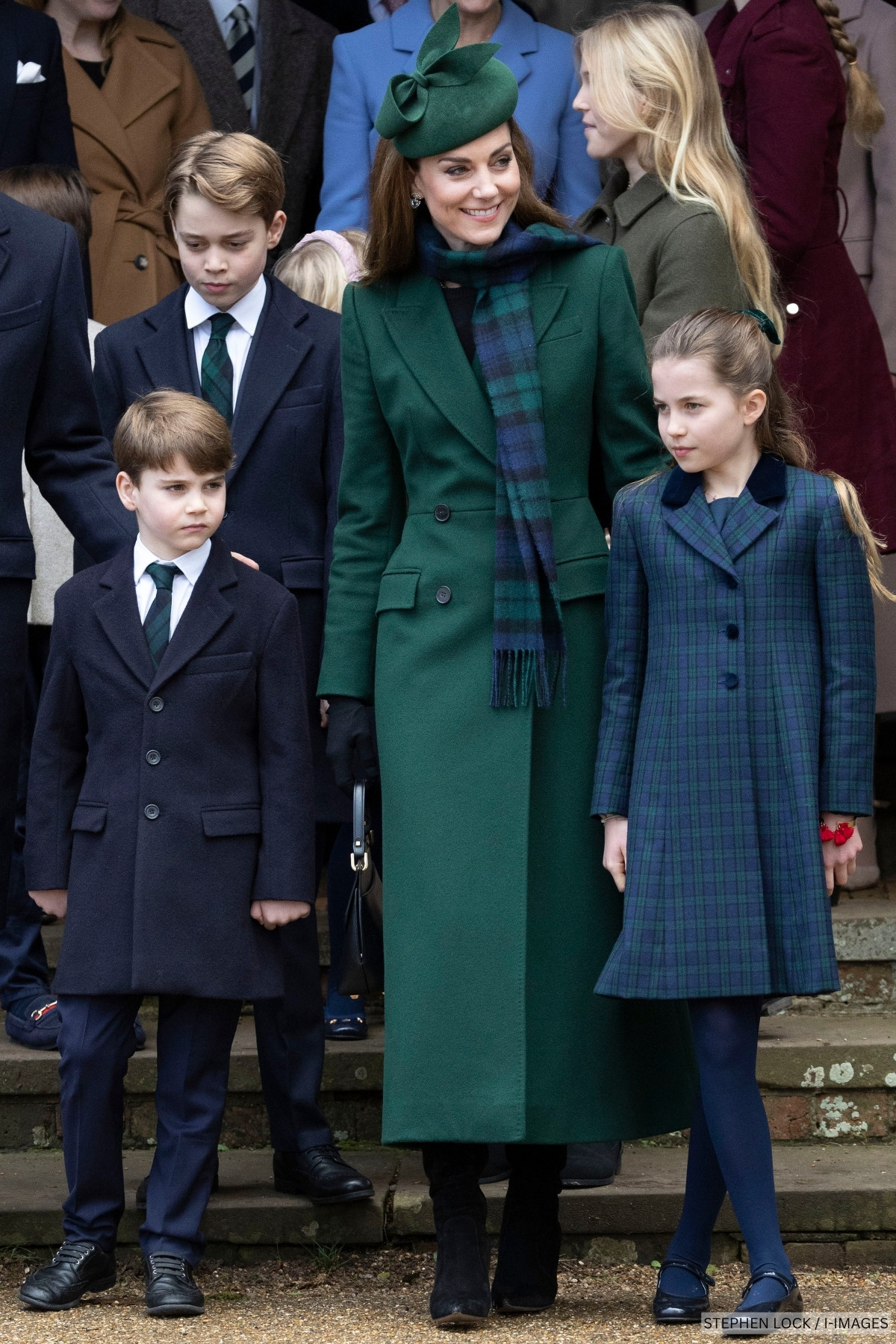 Kate Middleton walks with her children all wearing coordinating green and navy blue tartan outfits
