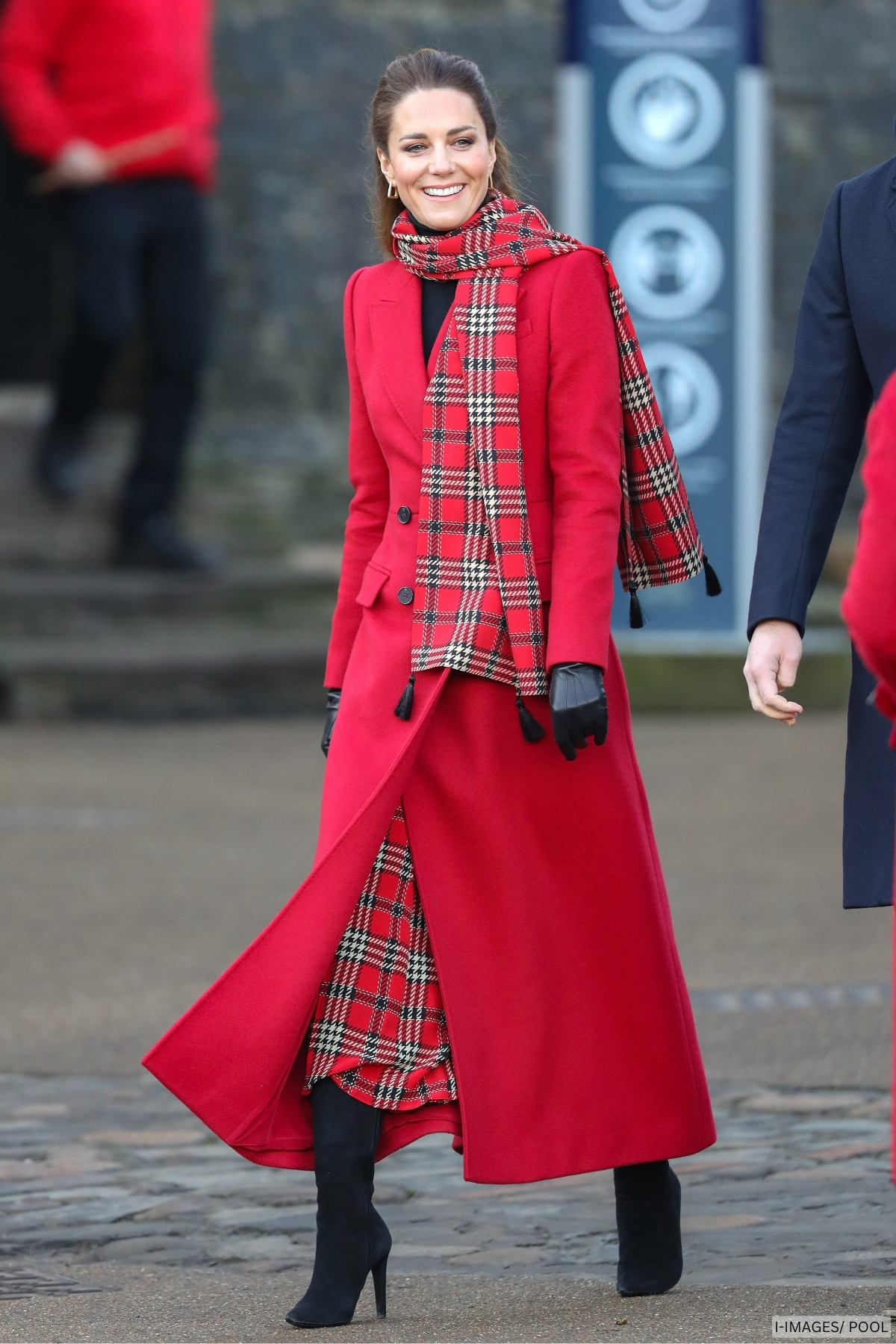 Kate Middleton during a visit to Cardiff wearing a long red wool coat and red tartan scarf