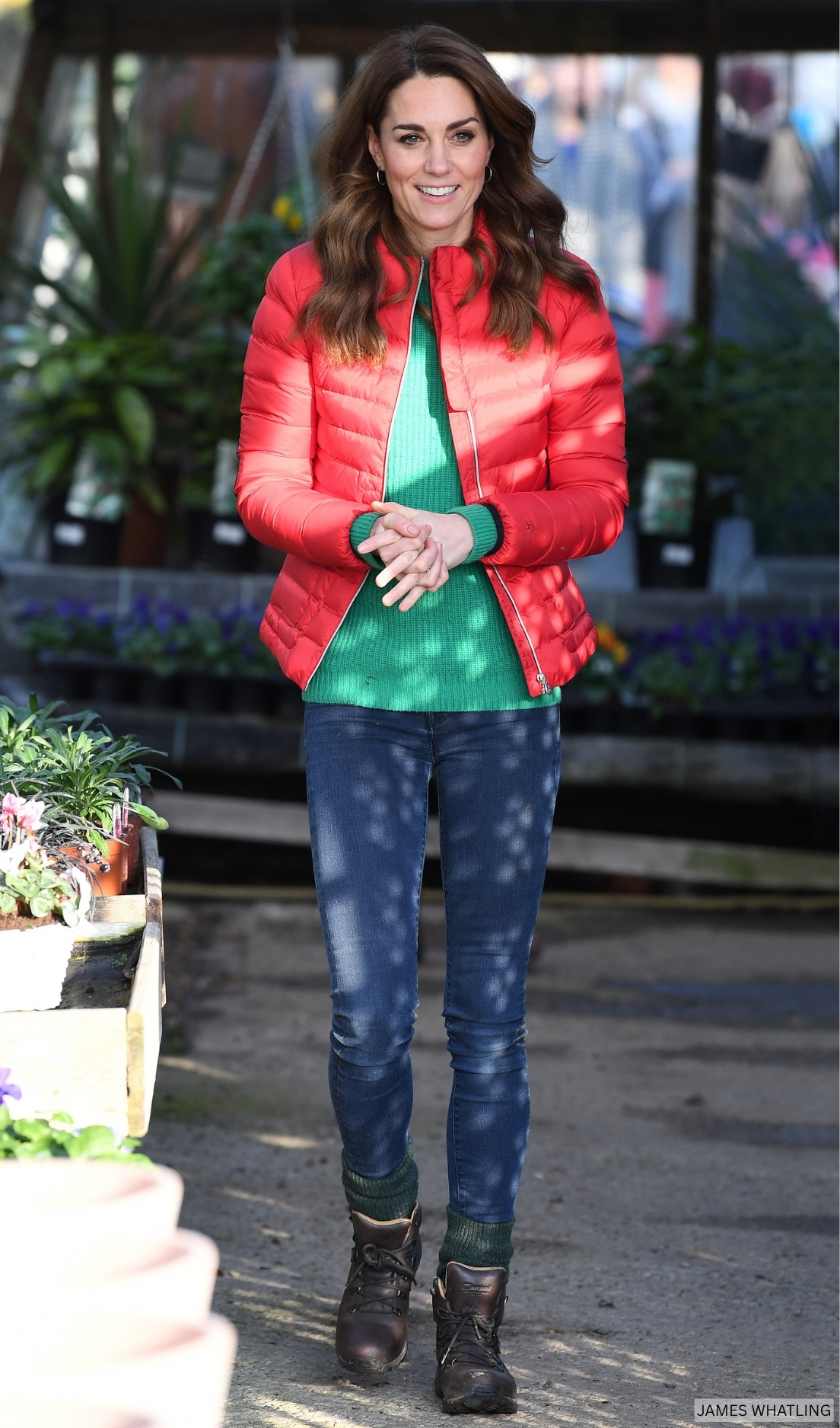 Kate Middleton dress casually during a visit to the Christmas tree farm, wearing a vibrant green sweater with a bright red puffer jacket