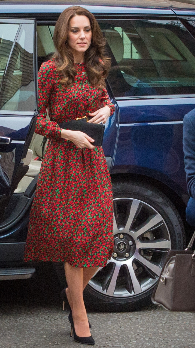 Kate Middleton walks into a Christmas party wearing a festive red and green print dress