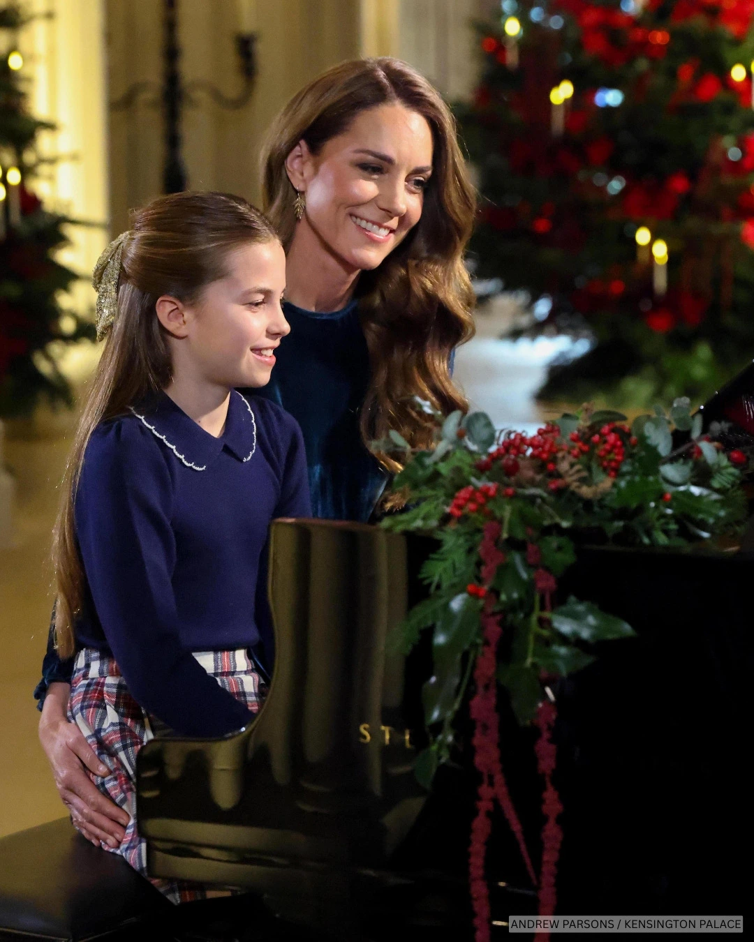 The Princess of Wales sits at a festive decorated piano with her daughter, Charlotte