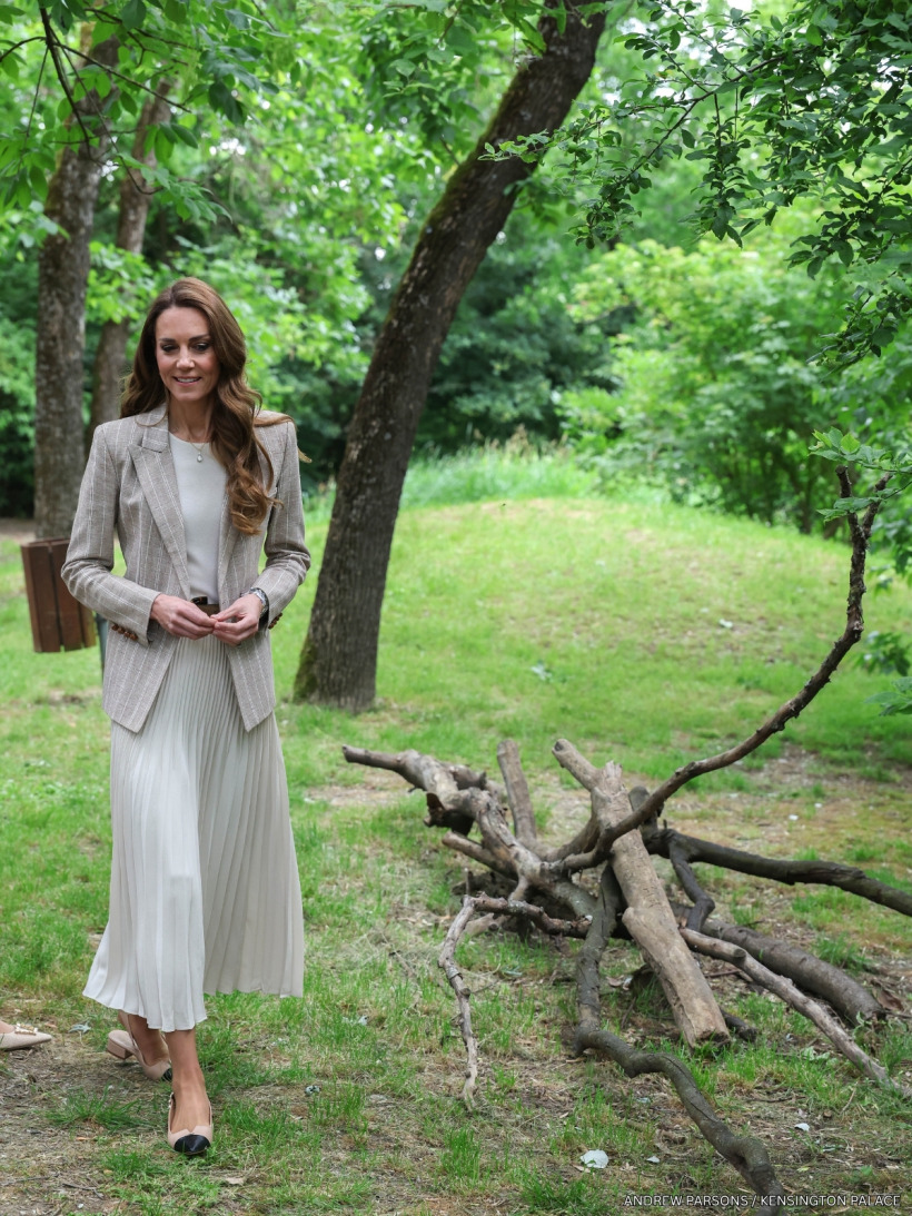 The Princess of Wales smiling in her beige Blazé Milano pinstripe blazer and ivory pleated skirt during her Italy visit.