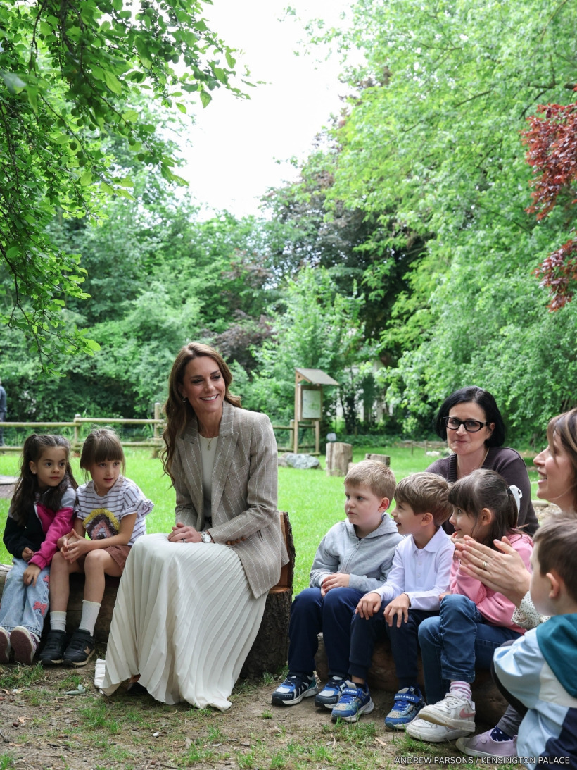 Kate Middleton sitting with children for a nature-based learning session in the Salvador Allende pre-school garden.