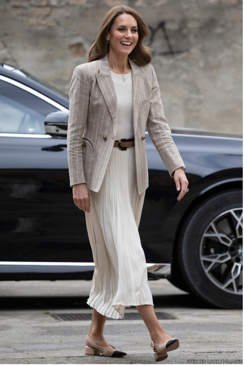 Kate Middleton arriving at the pre-school wearing a beige pinstripe Blazé Milano blazer, cream pleated maxi skirt and tan belt during day two of her visit to Reggio Emilia, Italy.
