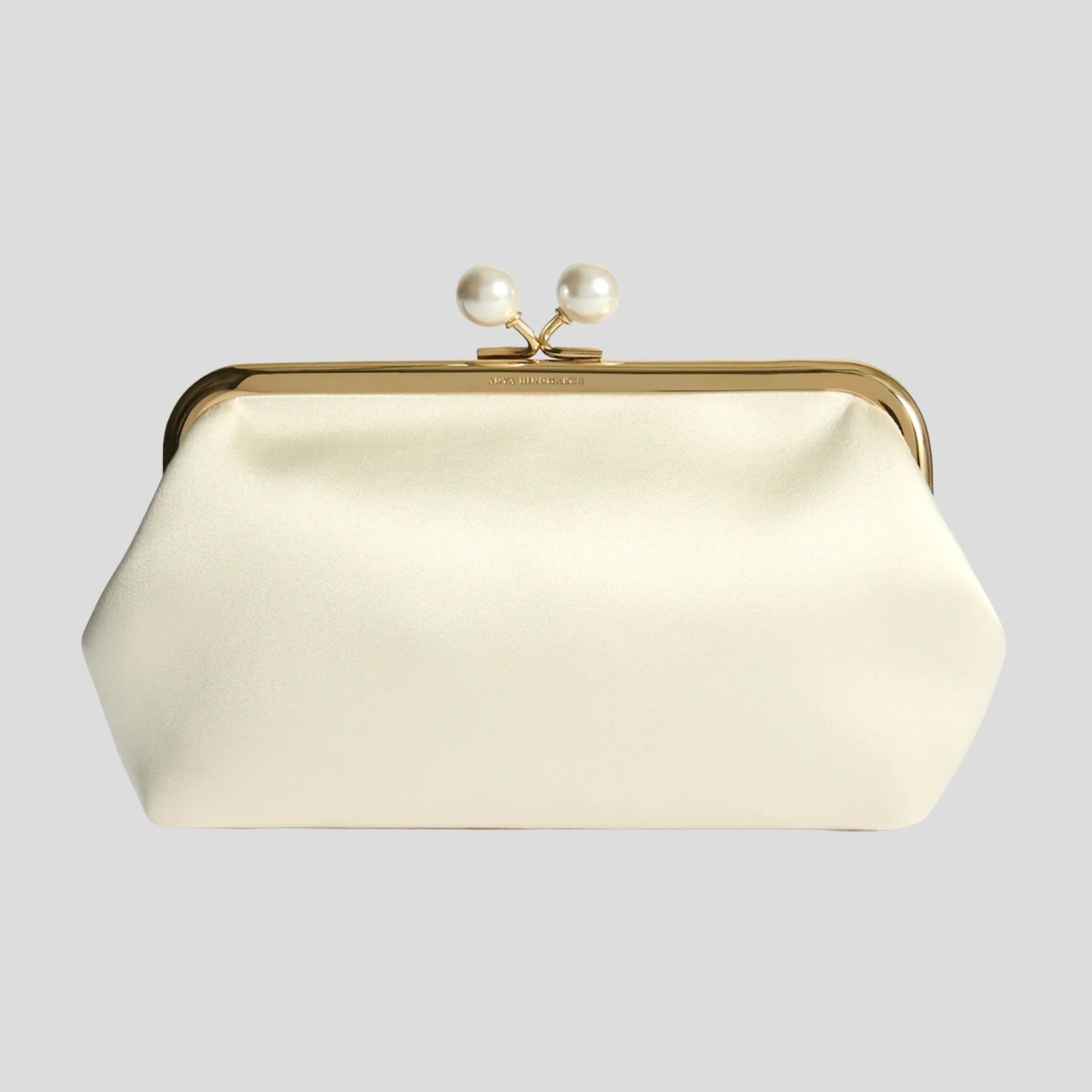 The Anya Hindmarch 'Maud' clutch in ivory satin with faux pearl embellishment and a gold frame